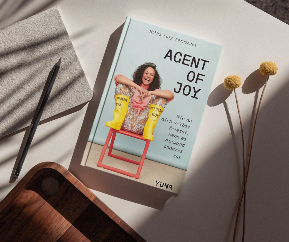 Milka Loff Fernandes, Agent of Joy Buch auf Tisch liegend